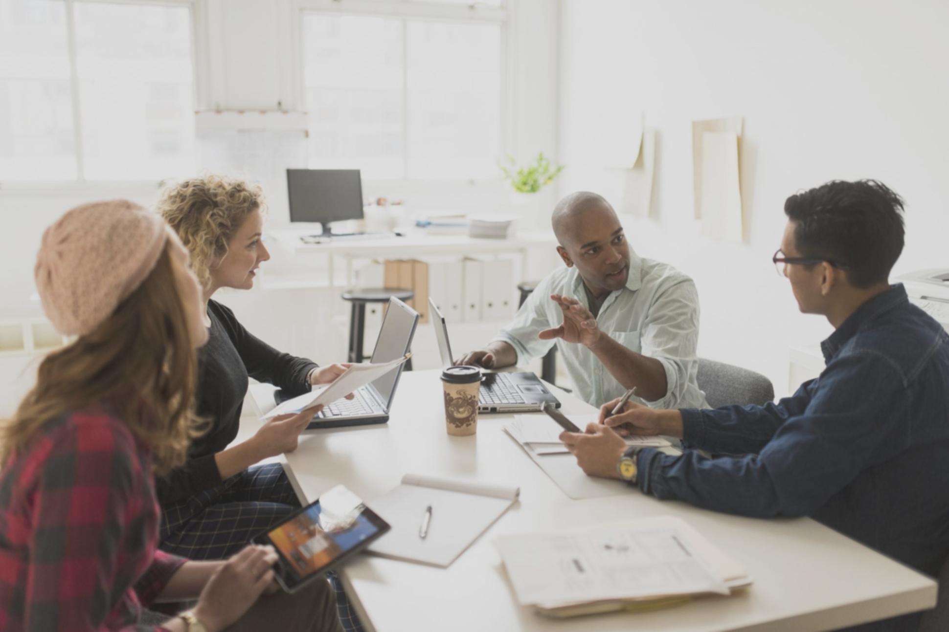 Team analyzing economic trends on multiple screens